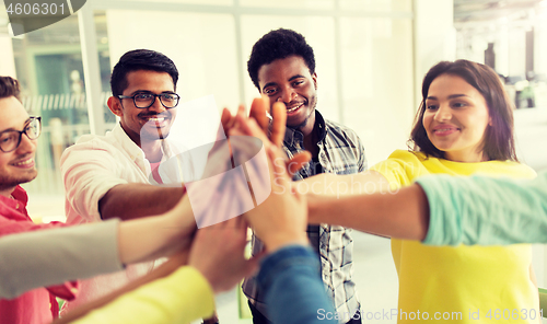 Image of group of international students making high five