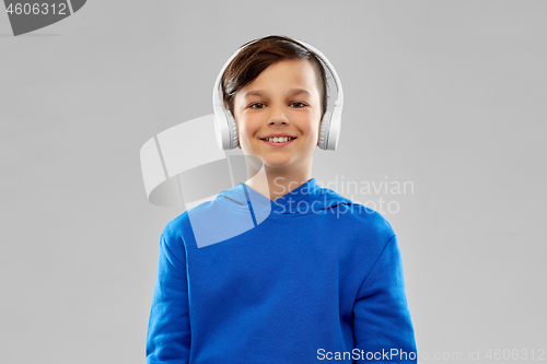 Image of portrait of smiling boy in blue hoodie