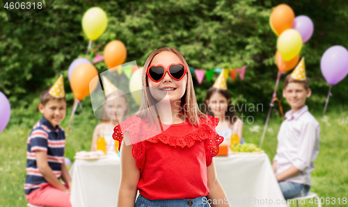 Image of girl in heart shaped sunglasses at birthday party