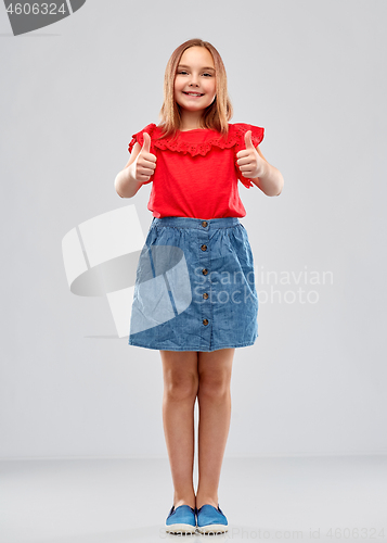Image of beautiful smiling girl showing thumbs up