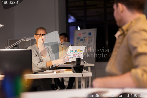 Image of designers or software developers at night office