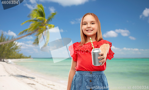 Image of smiling preteen girl drinking soda from can