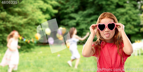 Image of naughty red haired girl in heart shaped sunglasses