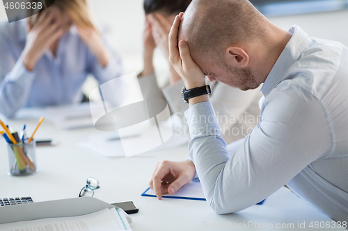 Image of stressed business team at office meeting