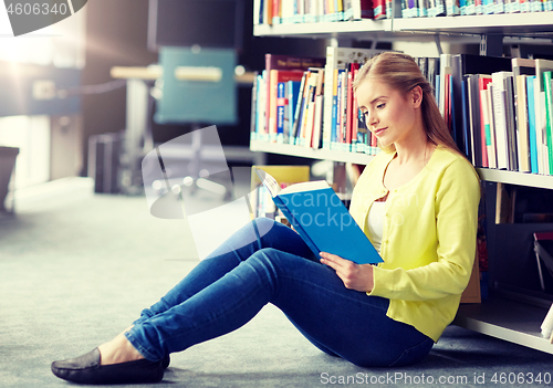 Image of high school student girl reading book at library