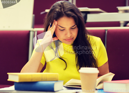 Image of student girl with books and coffee on lecture