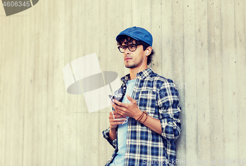 Image of man with earphones and smartphone listening music