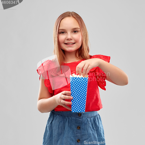 Image of beautiful smiling girl in red shirt and skirt