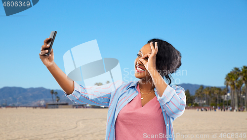 Image of african american woman taking selfie by smartphone