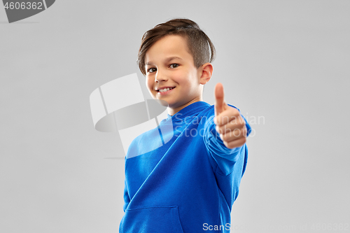 Image of smiling boy in blue hoodie showing thumbs up