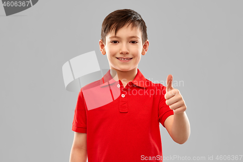 Image of smiling boy in red t-shirt showing thumbs up