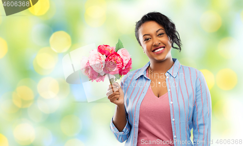 Image of happy african american woman with bunch of flowers