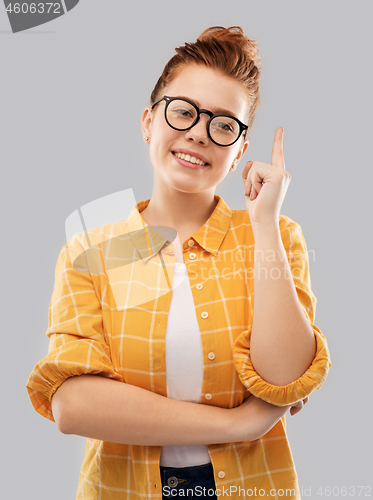 Image of smiling red haired teenage student girl in glasses