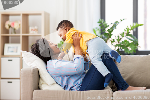 Image of happy african american mother with baby at home