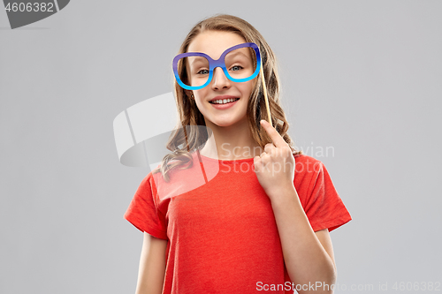 Image of smiling teenage girl with party glasses