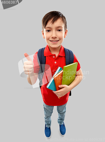 Image of student boy with books and bag showing thumbs up