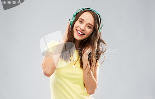 Image of happy young woman or teenage girl with headphones