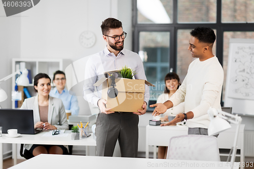 Image of new male employee meeting colleagues at office