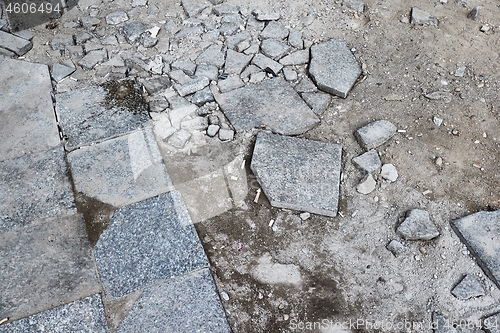 Image of Stone pavement broken near construction