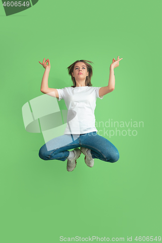 Image of Caucasian young woman\'s portrait on green studio background