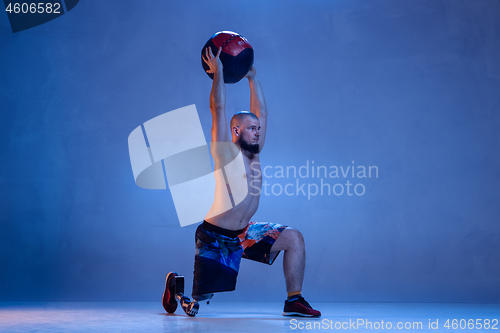 Image of Athlete disabled amputee isolated on blue studio background