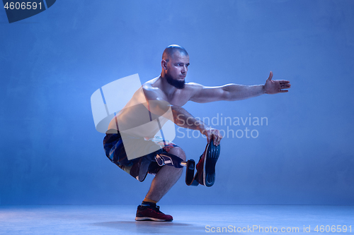 Image of Athlete disabled amputee isolated on blue studio background