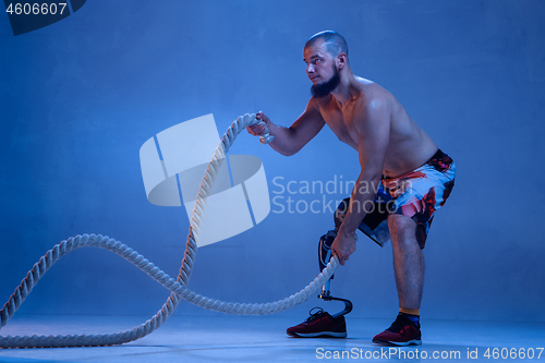 Image of Athlete disabled amputee isolated on blue studio background