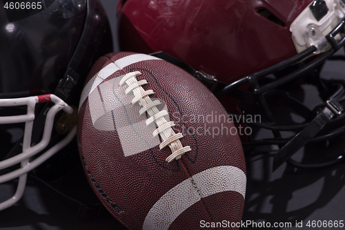 Image of american football and helmets isolated on gray