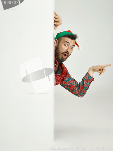 Image of friendly man dressed like a funny gnome posing on an isolated gray background