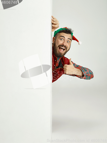 Image of friendly man dressed like a funny gnome posing on an isolated gray background