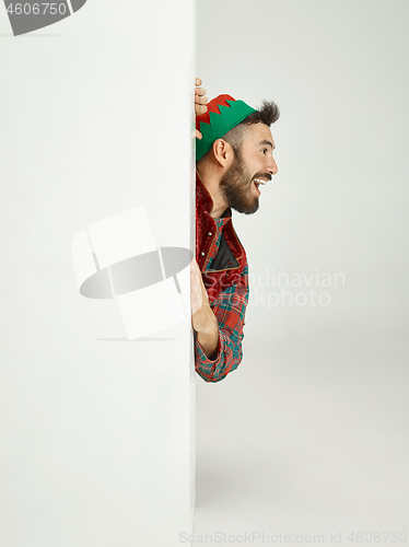 Image of friendly man dressed like a funny gnome posing on an isolated gray background