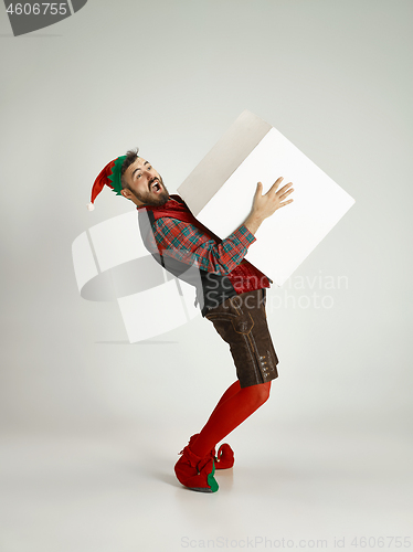 Image of friendly man dressed like a funny gnome posing on an isolated gray background