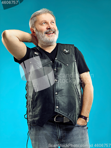 Image of Smiling middle-aged man happy expression posing in front of a blue background with copy space