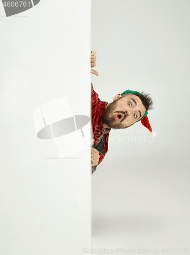 Image of friendly man dressed like a funny gnome posing on an isolated gray background