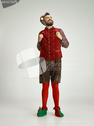 Image of friendly man dressed like a funny gnome posing on an isolated gray background