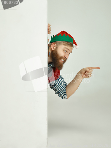 Image of friendly man dressed like a funny gnome posing on an isolated gray background