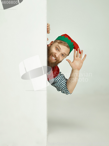 Image of friendly man dressed like a funny gnome posing on an isolated gray background