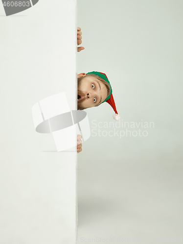 Image of friendly man dressed like a funny gnome posing on an isolated gray background