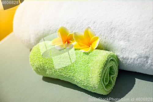 Image of Pretty yellow plumeria flowers on towels