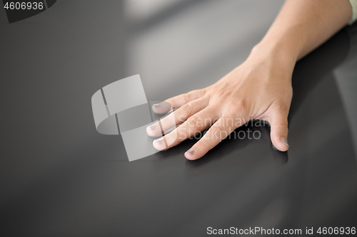 Image of hand using black interactive panel