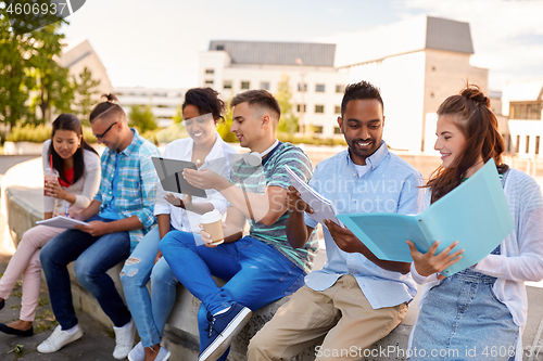 Image of group of happy students with notebooks and drinks