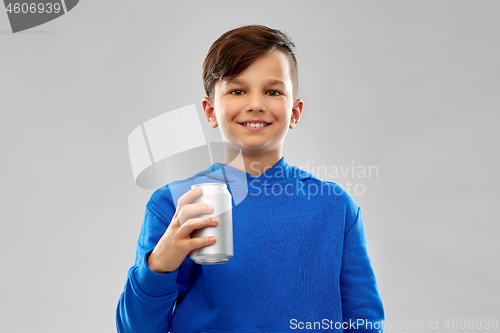 Image of smiling boy in blue hoodie holding can drink