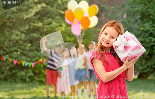 Image of lovely red haired girl with birthday gift at party