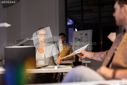 Image of designers or software developers at night office