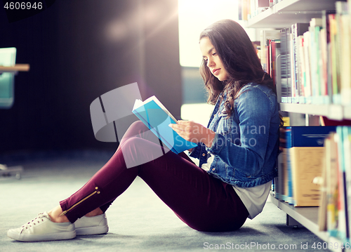 Image of high school student girl reading book at library