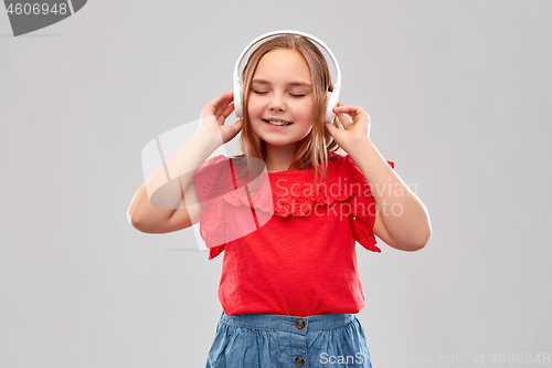 Image of smiling girl in headphones listening to music