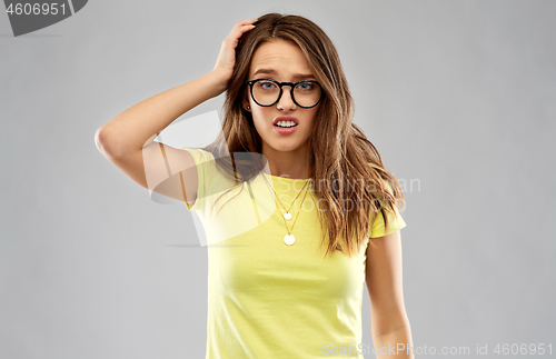 Image of confused young woman or teenage girl in glasses