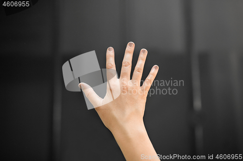 Image of hand using black interactive panel