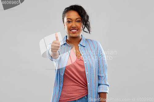 Image of happy african american woman showing thumbs up