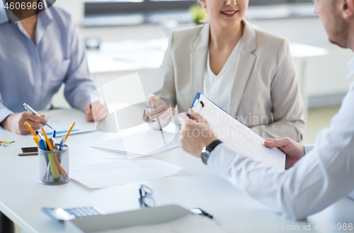 Image of business team discussing report at office
